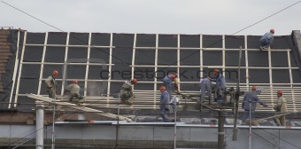 Roof workers on new roof