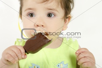 Baby girl eating an ice cream mini