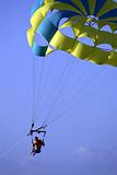 Male parasailing against blue sky