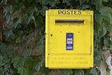 Yellow French post box on wall