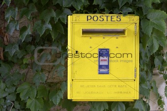 Yellow French post box on wall