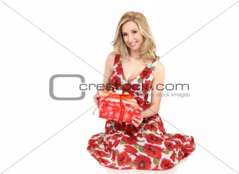 Smiling woman holding a wrapped present in her hands