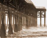 Sepia pier with ocean and sun rays