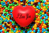 Soft red heart over candy background