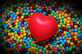 Soft red heart over candy background