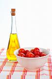 Olive oil bottle and red tomatos cherry
