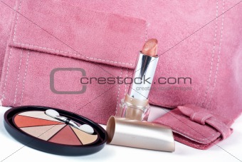 Detail of lipstick and Assortment of pink handbags