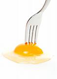 The fork pricking the raw egg