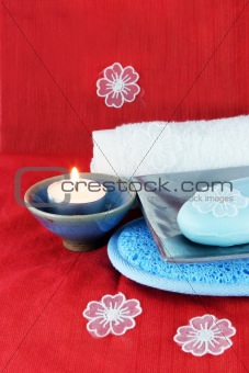 Burning candle with soap in a dish