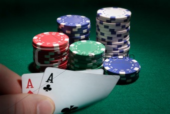Looking at pocket aces during a poker game.