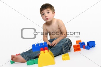 Young boy amongst building blocks