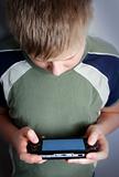 Boys hand playing portable video game
