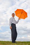Businessman with orange umbrella 