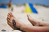 Tattoo foot in the sand