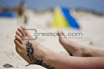 Tattoo foot in the sand