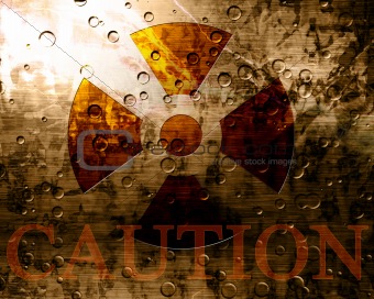 Worn nuclear sign with caution note