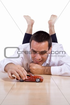 Man playing with toy car