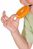 Closeup of kid eating an orange slice