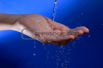 water stream poured on the woman's hand