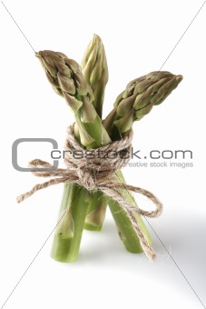 three asparagus spears tied by rope