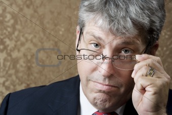 Businessman Lokking Over His Glasses