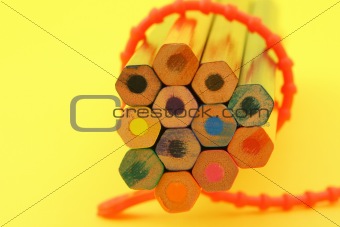 bunch of colorful pencils on yellow background