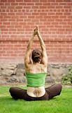 Woman with a Tattoo on Her Back Doing Yoga