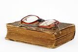 broken eyeglasses and book