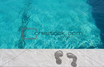 Feet by the swimming pool