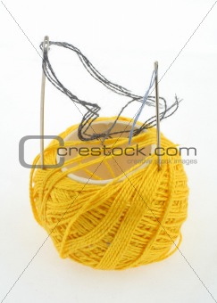 yellow thread and needles on white