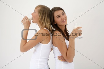 two girls drinking milk