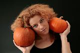 curly redhead holding two pumpkins