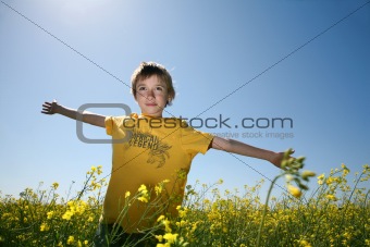 Joyful boy in canola field
