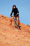 Girl downhill on red loam hills