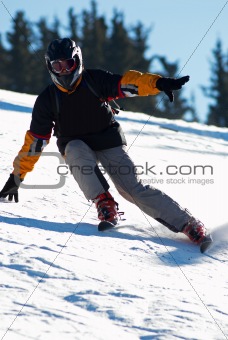 Fast mountain skier downhill on ski resort slope