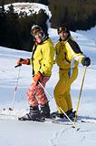 Yong family skiers in yellow on ski slope