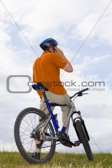 Man with bicycle making a phone call