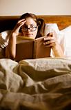 Woman Reading in Bed
