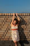 woman against brick wall