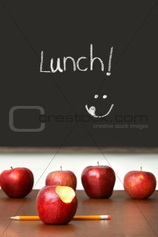 Apples on top of school desk