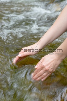 Female hands scooping water