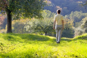 Woman walking in a autumn landscape
