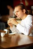 Young man and cup of coffee