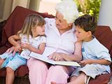 Grandmother reading to grandchildren