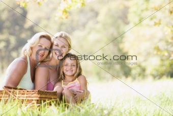 Grandmother with adult daughter and grandchild on picnic