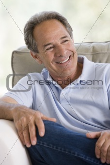 Man sitting in living room smiling