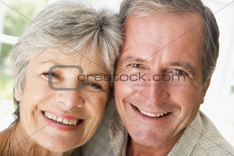 Couple relaxing indoors smiling