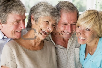 Two couples indoors smiling