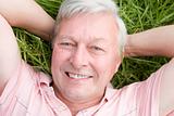Man lying in grass smiling