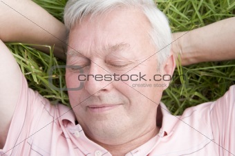 Man lying in grass sleeping